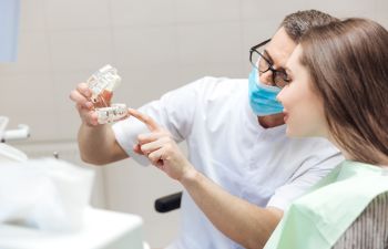 Dentist Consulting with Patient About Bone Grafting