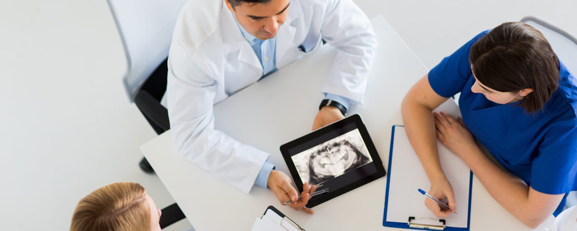 medical staff discussing x-ray picture on table