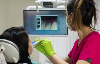 A dentist using introral camera for a diagnosis.