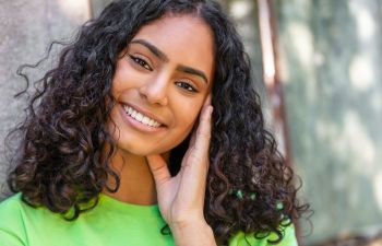 A cheerful teenage girl with a perfect smile.