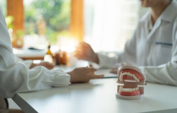 A dentist and a patient discussing restorative treatment options.